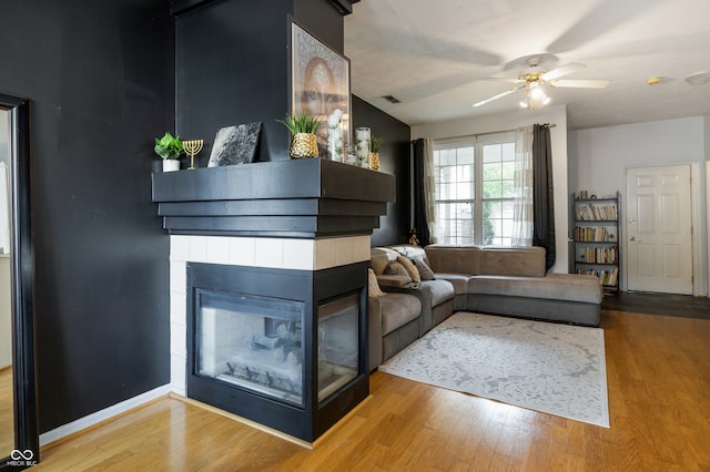 9525 Longwell Dr, Indianapolis, IN 46240 - living room with wood finished floors, ceiling fan, and a multi sided fireplace
