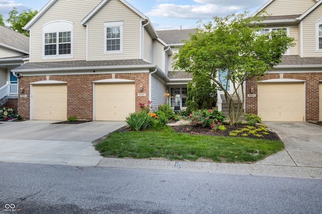 9525 Longwell Dr, Indianapolis, IN 46240 - view of front facade with driveway, a garage, and brick siding