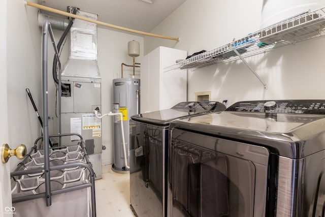 9525 Longwell Dr, Indianapolis, IN 46240 - washroom featuring water heater, independent washer and dryer, and light flooring