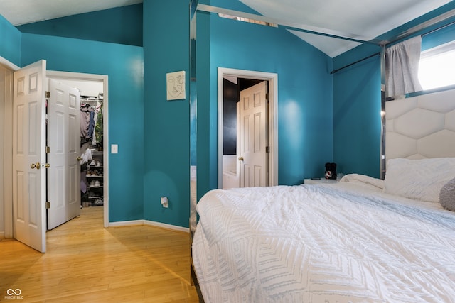 9525 Longwell Dr, Indianapolis, IN 46240 - bedroom featuring lofted ceiling, a walk in closet, light wood-style floors, and a closet