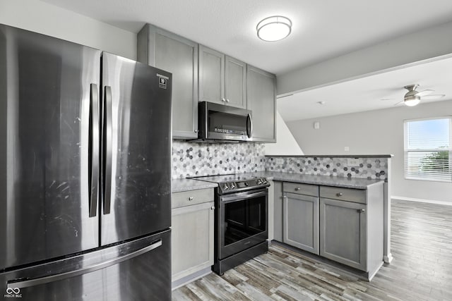 1236 N Aberdeen Dr, Franklin, IN 46131 - kitchen with appliances with stainless steel finishes, gray cabinets, a peninsula, and backsplash