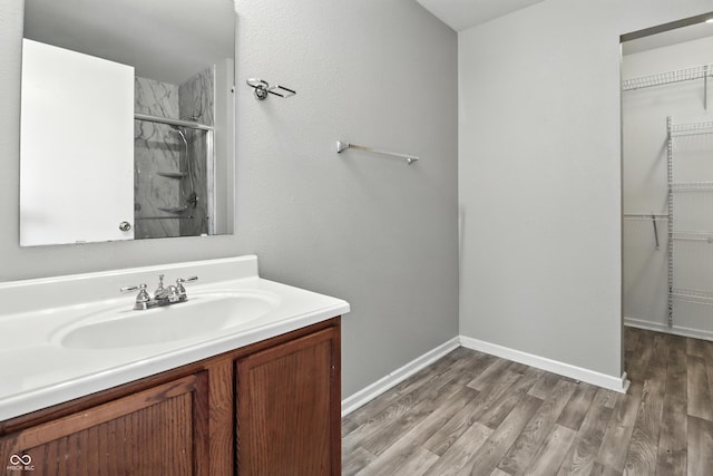 1236 N Aberdeen Dr, Franklin, IN 46131 - full bathroom featuring a shower with door, vanity, wood finished floors, and a walk in closet