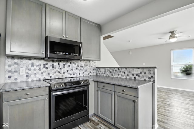 1236 N Aberdeen Dr, Franklin, IN 46131 - kitchen featuring appliances with stainless steel finishes, gray cabinets, a peninsula, and light wood-style floors