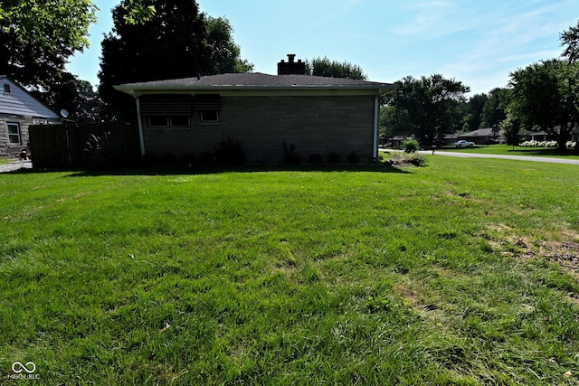 136 W Loretta Dr, Indianapolis, IN 46217 - view of home's exterior with a chimney and stone siding