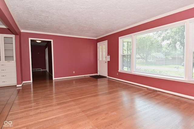 136 W Loretta Dr, Indianapolis, IN 46217 - unfurnished living room featuring light wood-style floors, a textured ceiling, and crown molding