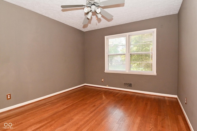 136 W Loretta Dr, Indianapolis, IN 46217 - unfurnished room featuring wood finished floors, a textured ceiling, and a ceiling fan