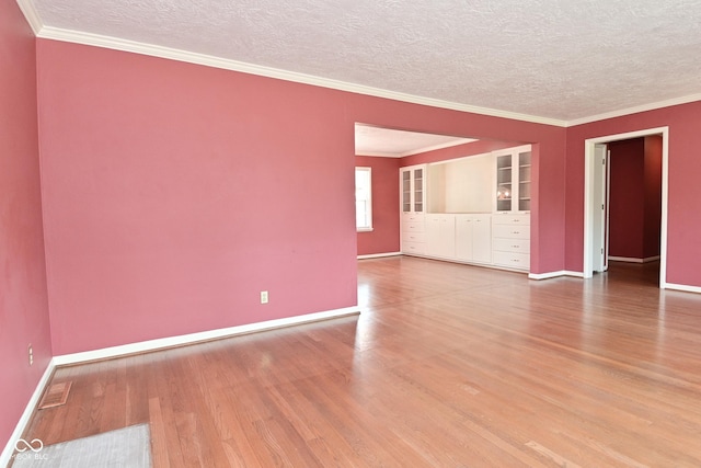136 W Loretta Dr, Indianapolis, IN 46217 - spare room featuring a textured ceiling, wood finished floors, and ornamental molding