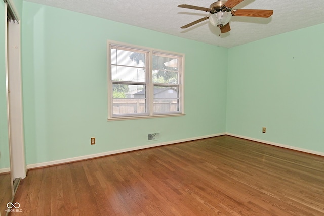 136 W Loretta Dr, Indianapolis, IN 46217 - empty room featuring wood finished floors, a textured ceiling, and a ceiling fan