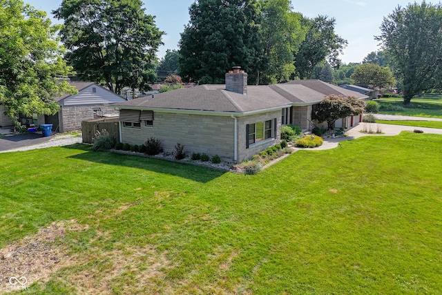 136 W Loretta Dr, Indianapolis, IN 46217 - view of side of home featuring stone siding, a lawn, and a chimney