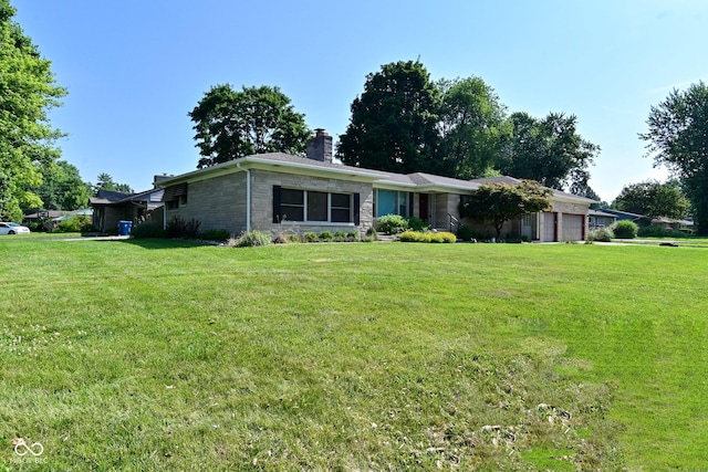 136 W Loretta Dr, Indianapolis, IN 46217 - single story home featuring an attached garage, a chimney, stone siding, and a front yard