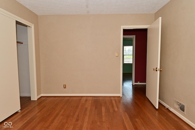 136 W Loretta Dr, Indianapolis, IN 46217 - unfurnished bedroom with wood finished floors and a textured ceiling