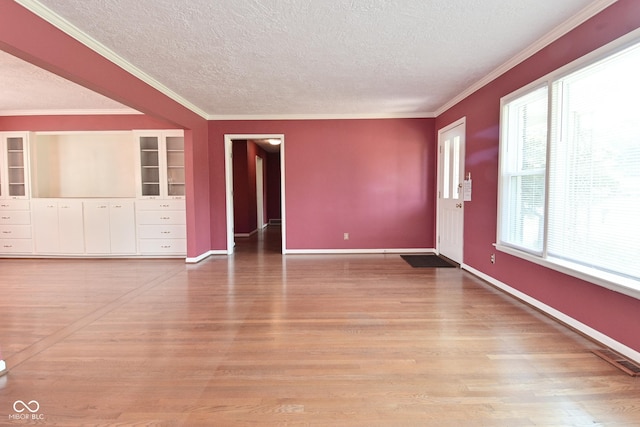 136 W Loretta Dr, Indianapolis, IN 46217 - spare room with a textured ceiling, ornamental molding, light wood-style flooring, and built in shelves