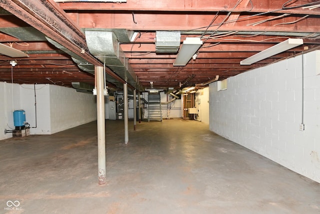 136 W Loretta Dr, Indianapolis, IN 46217 - unfinished below grade area with a water pressure tank, concrete block wall, and stairs