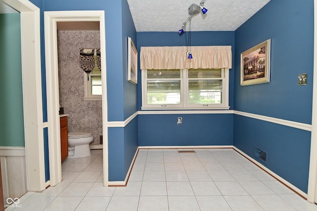 136 W Loretta Dr, Indianapolis, IN 46217 - bathroom featuring a textured ceiling and tile patterned flooring