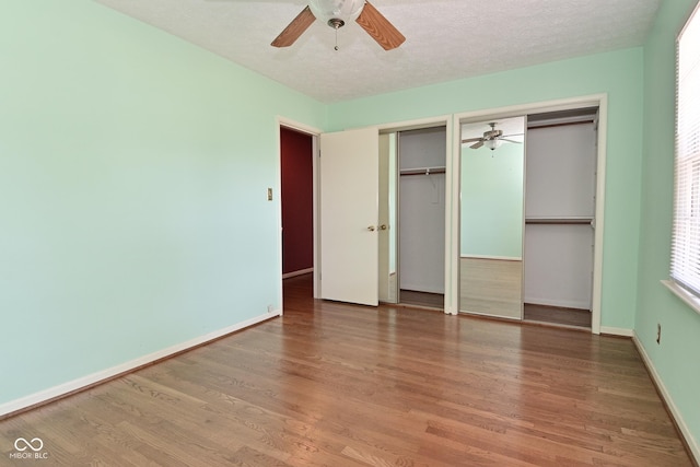 136 W Loretta Dr, Indianapolis, IN 46217 - unfurnished bedroom with two closets, wood finished floors, and ceiling fan