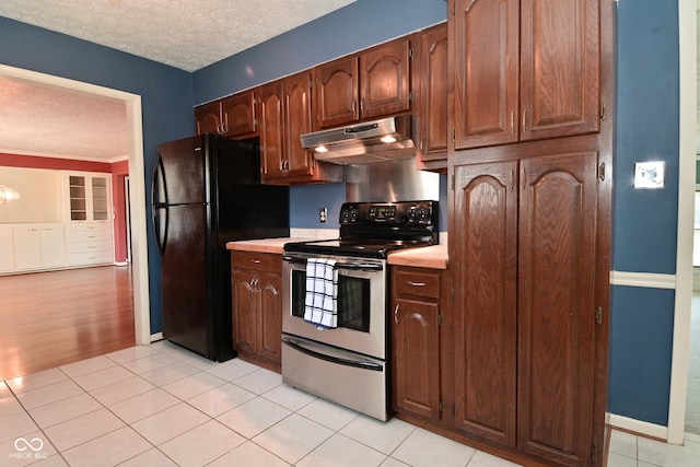 136 W Loretta Dr, Indianapolis, IN 46217 - kitchen with electric range, under cabinet range hood, freestanding refrigerator, a textured ceiling, and light countertops