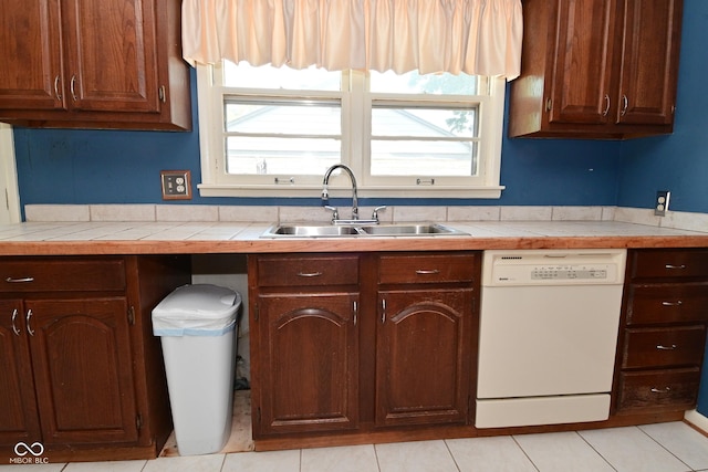 136 W Loretta Dr, Indianapolis, IN 46217 - kitchen with white dishwasher, tile counters, and healthy amount of natural light