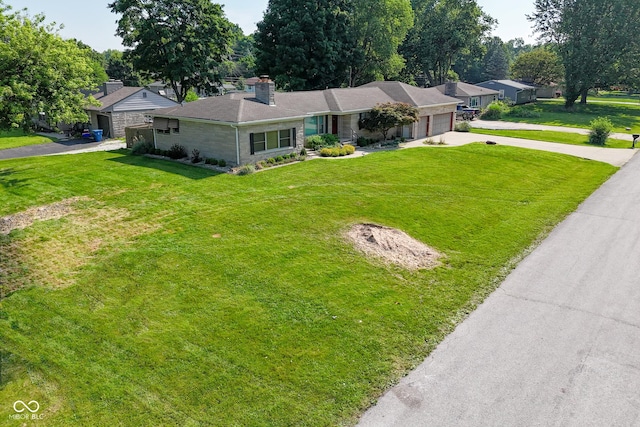 136 W Loretta Dr, Indianapolis, IN 46217 - single story home featuring driveway, an attached garage, a chimney, and a front yard