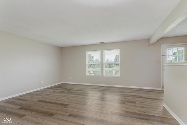 7572 Wymm Ln, Ingalls, IN 46048 - spare room featuring wood finished floors and beam ceiling