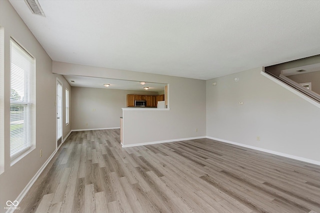 7572 Wymm Ln, Ingalls, IN 46048 - unfurnished living room featuring light wood finished floors and baseboards