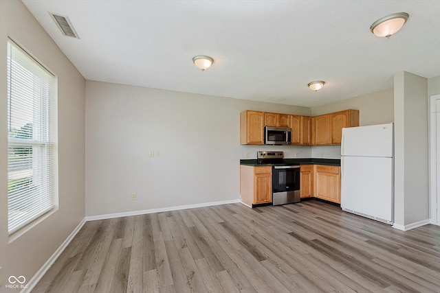 7572 Wymm Ln, Ingalls, IN 46048 - kitchen with appliances with stainless steel finishes, light wood-type flooring, and dark countertops