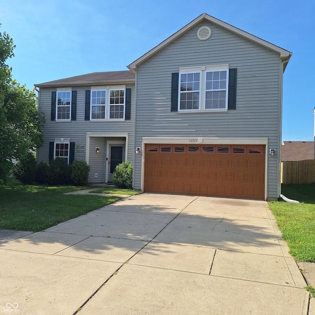 10775 Cyrus Dr, Indianapolis, IN 46231 - view of front facade with a front yard, an attached garage, and driveway