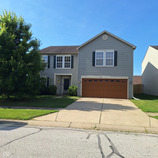 10775 Cyrus Dr, Indianapolis, IN 46231 - view of front of house featuring a garage, driveway, and a front lawn