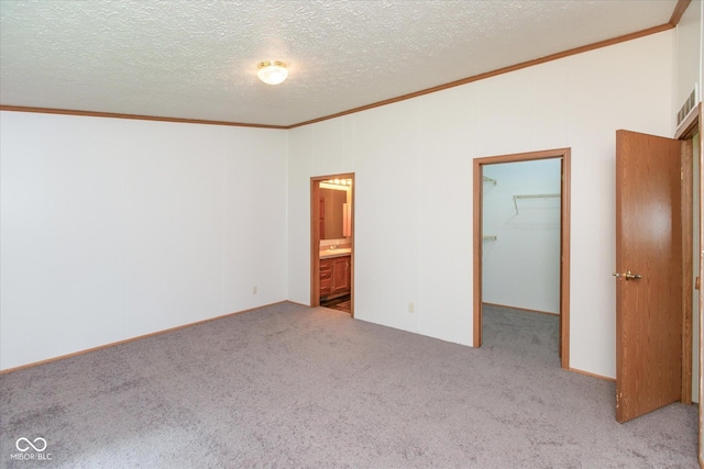 305 Pike St, Darlington, IN 47940 - unfurnished bedroom with ornamental molding, carpet, a spacious closet, a textured ceiling, and lofted ceiling