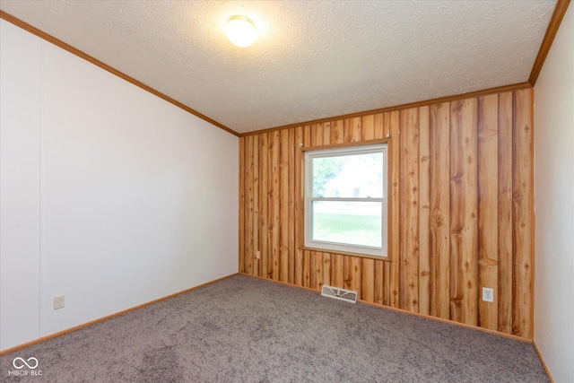 305 Pike St, Darlington, IN 47940 - carpeted spare room with ornamental molding, a textured ceiling, and wooden walls