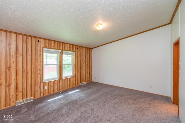 305 Pike St, Darlington, IN 47940 - carpeted empty room with crown molding, a textured ceiling, and wooden walls