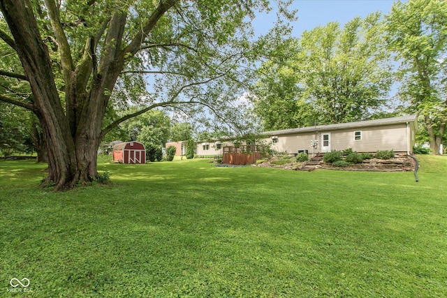 305 Pike St, Darlington, IN 47940 - view of grassy yard with a storage shed and a deck
