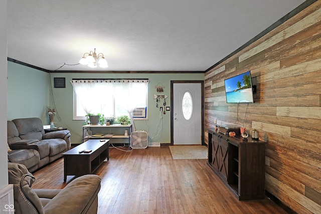 2587 E State Road 55, Wingate, IN 47994 - living area featuring wood walls, a chandelier, crown molding, wood-type flooring, and an accent wall