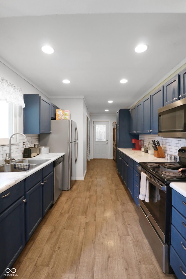 2587 E State Road 55, Wingate, IN 47994 - kitchen featuring appliances with stainless steel finishes, blue cabinetry, tasteful backsplash, light countertops, and recessed lighting
