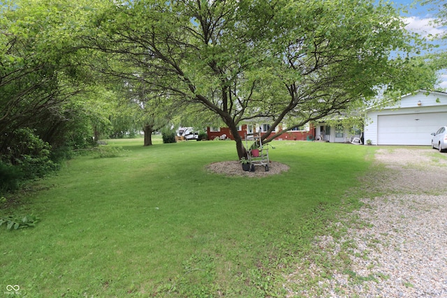 2587 E State Road 55, Wingate, IN 47994 - view of grassy yard featuring driveway and an attached garage
