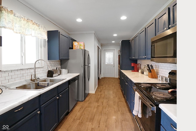 2587 E State Road 55, Wingate, IN 47994 - kitchen featuring stainless steel appliances, blue cabinetry, light wood-style flooring, backsplash, and ornamental molding