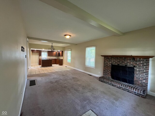 1900 S 25th St, Terre Haute, IN 47802 - unfurnished living room featuring light carpet, a fireplace, a chandelier, and beamed ceiling