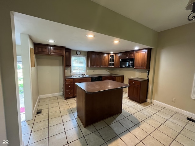1900 S 25th St, Terre Haute, IN 47802 - kitchen with black appliances, light tile patterned flooring, dark countertops, a kitchen island, and recessed lighting