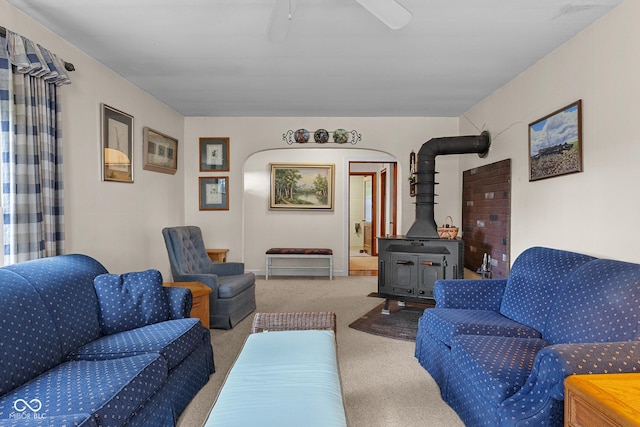 9030 E 700 S, Elizabethtown, IN 47232 - living room featuring a wood stove, carpet, and a ceiling fan