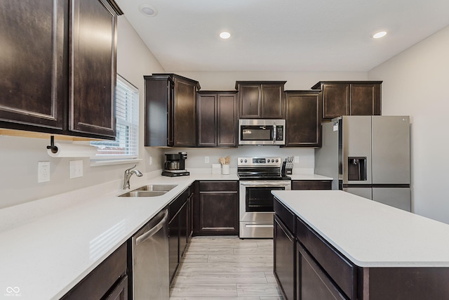 5809 Terracotta Trce, Mccordsville, IN 46055 - kitchen featuring stainless steel appliances, dark brown cabinetry, a center island, light countertops, and recessed lighting