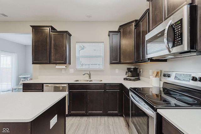 5809 Terracotta Trce, Mccordsville, IN 46055 - kitchen featuring appliances with stainless steel finishes, light countertops, dark brown cabinets, and light wood-type flooring