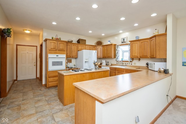 439 Alisa Ave, Seymour, IN 47274 - kitchen with white appliances, a center island, recessed lighting, a peninsula, and light countertops