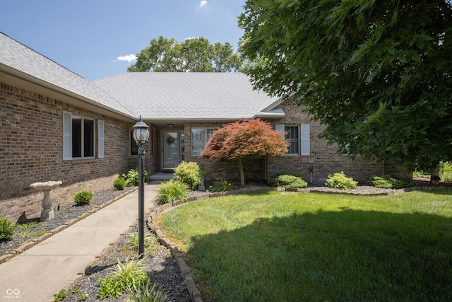 439 Alisa Ave, Seymour, IN 47274 - view of front of house with a front lawn, brick siding, and roof with shingles