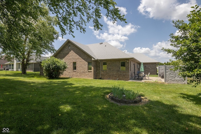 439 Alisa Ave, Seymour, IN 47274 - back of property with a patio, brick siding, and a yard