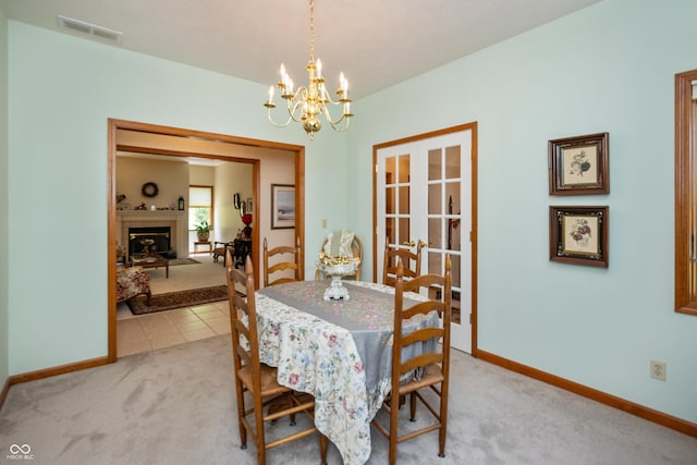 439 Alisa Ave, Seymour, IN 47274 - dining area with light carpet, a chandelier, and a fireplace