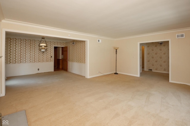 660 E Dr, Seymour, IN 47274 - empty room featuring wallpapered walls, carpet, crown molding, and a wainscoted wall