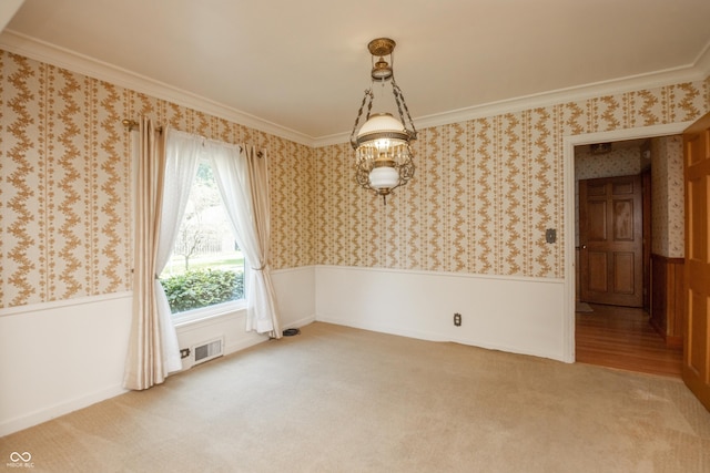 660 E Dr, Seymour, IN 47274 - unfurnished room with a wainscoted wall, light carpet, crown molding, and wallpapered walls