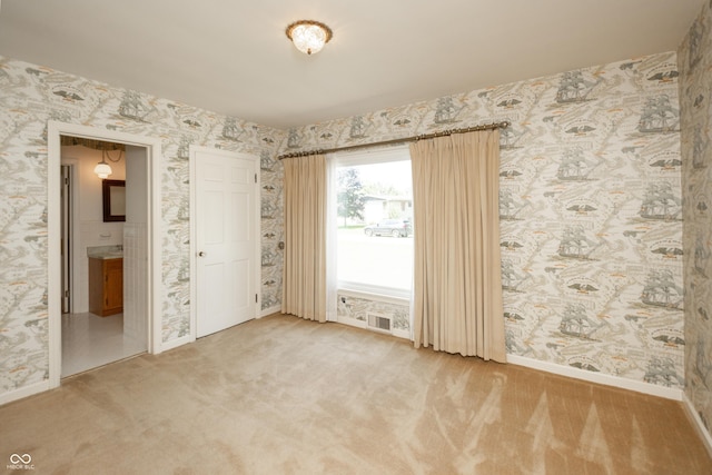 660 E Dr, Seymour, IN 47274 - carpeted empty room featuring baseboards and wallpapered walls