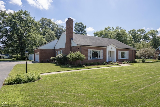 660 E Dr, Seymour, IN 47274 - view of front of property with brick siding, a front lawn, a chimney, and a garage