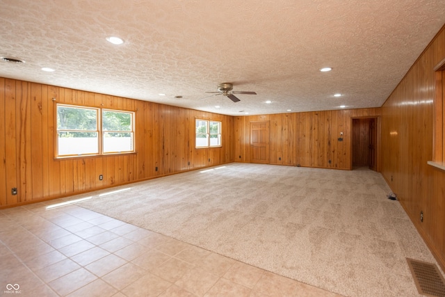 660 E Dr, Seymour, IN 47274 - unfurnished room featuring a ceiling fan, recessed lighting, wooden walls, a textured ceiling, and light colored carpet