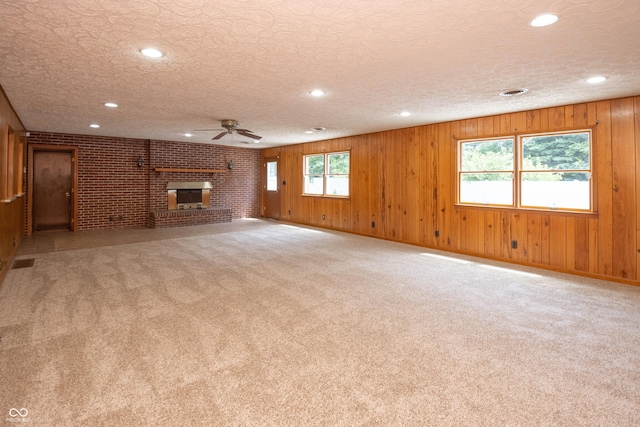 660 E Dr, Seymour, IN 47274 - unfurnished living room with a ceiling fan, a fireplace, carpet flooring, recessed lighting, and a textured ceiling